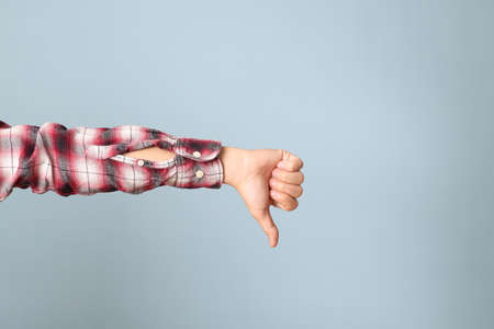 The Asian man hand with plaid shirt showing on the blue background.の写真素材