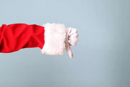 The Santa Claus hand showing on the blue background.の写真素材
