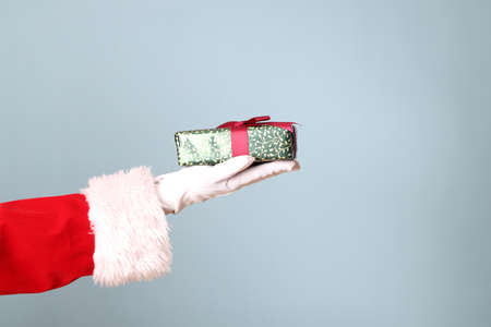 The Santa Claus hand showing on the blue background.の写真素材