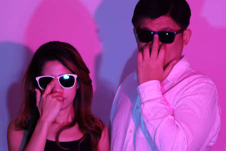 The cool  Asian couple in the gel color light photography.の写真素材