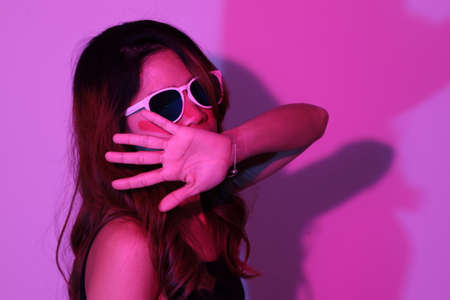 The cool  Asian couple in the gel color light photography.の写真素材