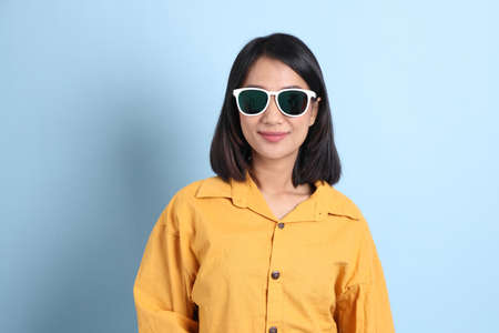 The mixed race girl portrait sitting on the blue background.の写真素材