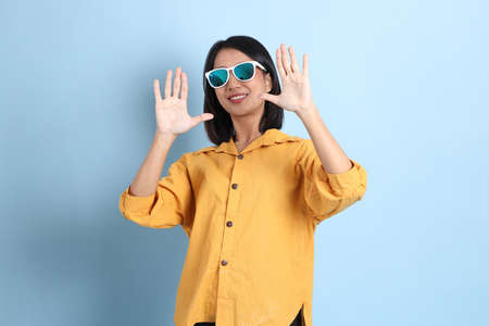 The mixed race girl portrait sitting on the blue background.の写真素材