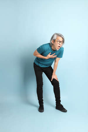 The senior Asian man on the blue background.