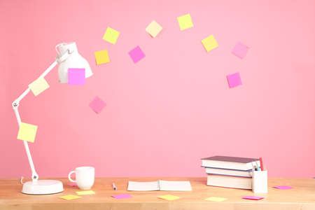 The working desk without people on the pink wall.の写真素材