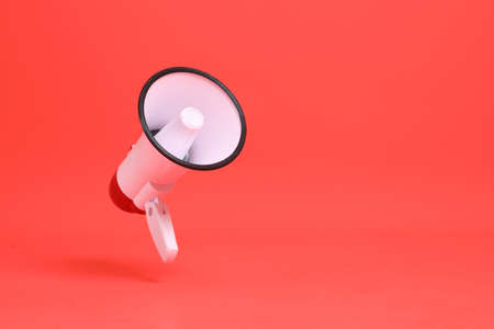 The isolated picture of megaphone floating on the orange background.の写真素材