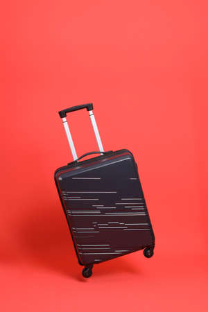 The isolated of luggage floating on the orange background.