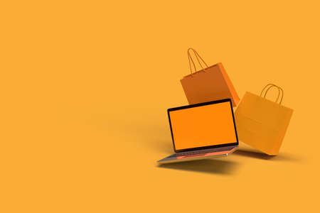 The 3d Rendering of shopping bags and laptop floating mid air on the color background.の写真素材
