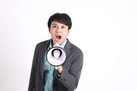 The young adult businessman standing on the white background.