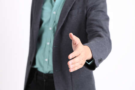 The young adult businessman standing on the white background.の写真素材