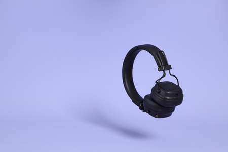 The isolated picture of headphone floating on the purple background.の写真素材