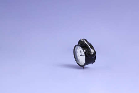 The isolated picture of clock floating on the purple background.