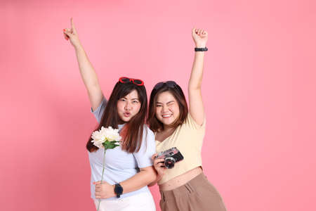 The Asian family in casual clothes standing on the pink background.の写真素材