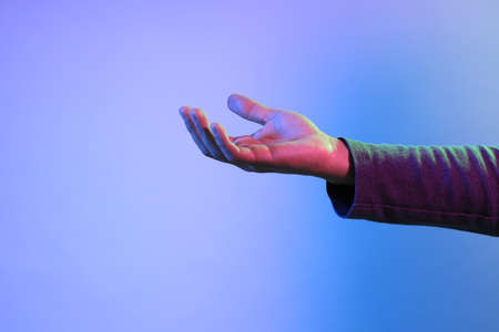 The Asian man s hands under the vivid color lighs.の写真素材