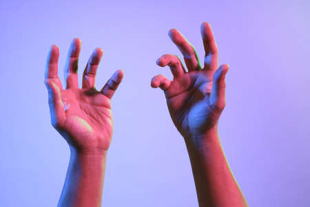 The Asian man s hands under the vivid color lighs.の写真素材