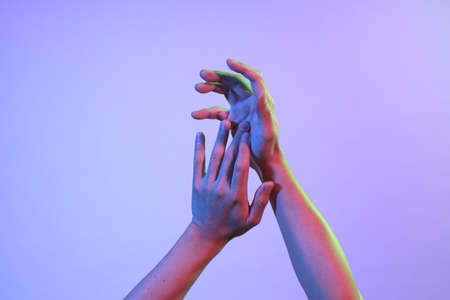 The Asian man s hands under the vivid color lighs.の写真素材