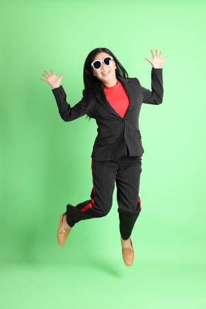 The Asian businesswoman standing on the pastel green background.の写真素材