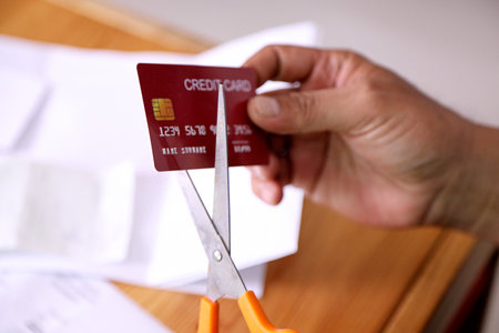 The 40s adult Asian man using scissors to cut the credit card.の写真素材