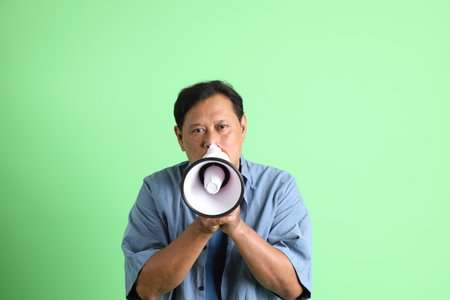 The 40s adult overweight Asian man standing on the green background.の写真素材