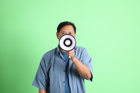 The 40s adult overweight Asian man standing on the green background.の写真素材