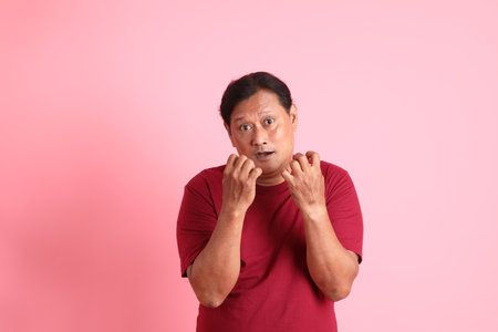 The 40s adult overweight Asian man standing on the pink background.の写真素材