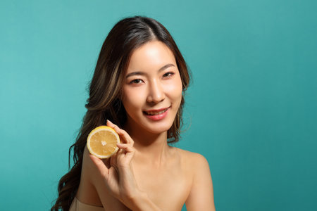 The beautiful  Asian woman showing skin with green backgroundの写真素材