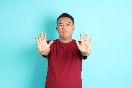 The 40s adult Asian man with standing on the green background.の写真素材