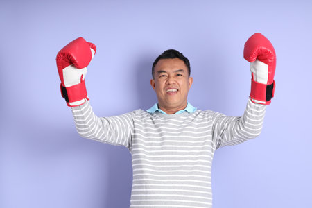 The 40s adult Asian man with standing on the purple background.の写真素材