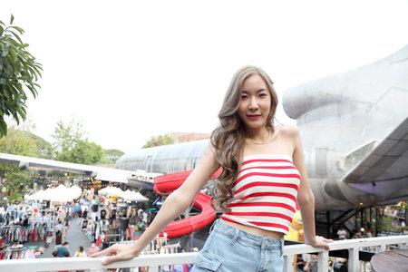 The cute Asian girl traveling at the Thailand night market in the daytime and nighttime.