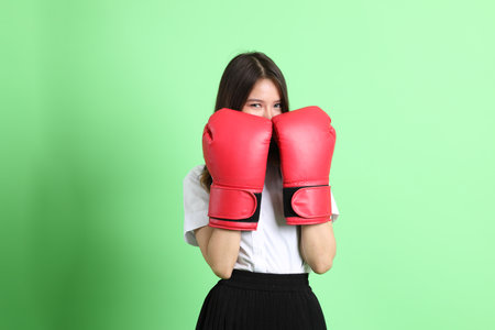 The young school girl with uniform standing on the green background.の写真素材