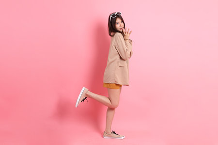 The young adult Asian woman with casual clothes on the pink background.の写真素材