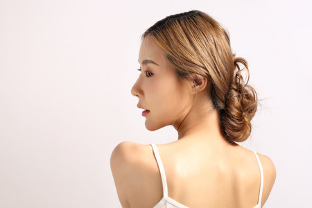 The beautiful Asian woman showing clear skin on the white background.の写真素材