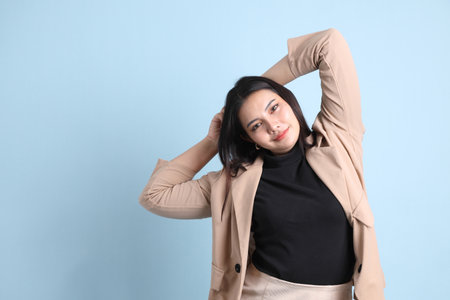 The Asian businesswoman standing on the blue background.の写真素材