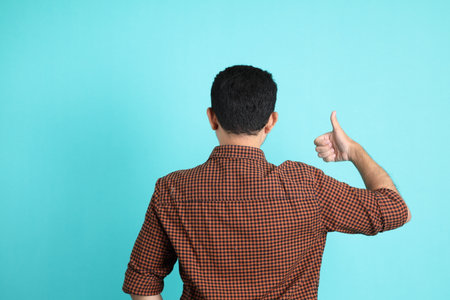 The adult Asian man in smart casual clothes standing on the green background background.の写真素材
