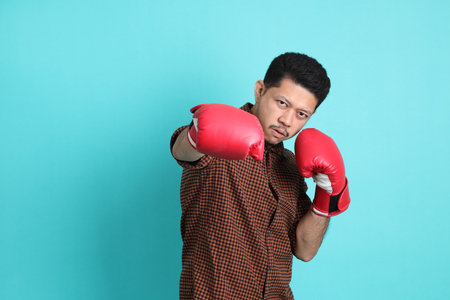 The adult Asian man in smart casual clothes standing on the green background background.の写真素材