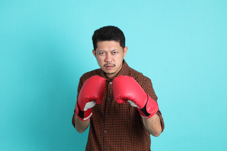 The adult Asian man in smart casual clothes standing on the green background background.