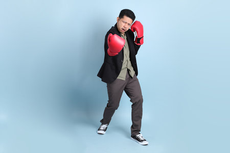 The adult business Asian man in smart casual clothes standing on the green background background.の写真素材