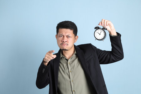 The adult business Asian man in smart casual clothes standing on the green background background.の写真素材