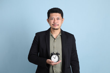 The adult business Asian man in smart casual clothes standing on the green background background.の写真素材