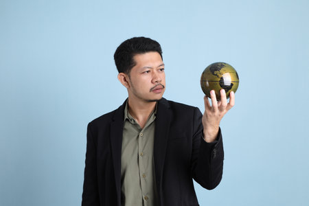 The adult business Asian man in smart casual clothes standing on the green background background.の写真素材