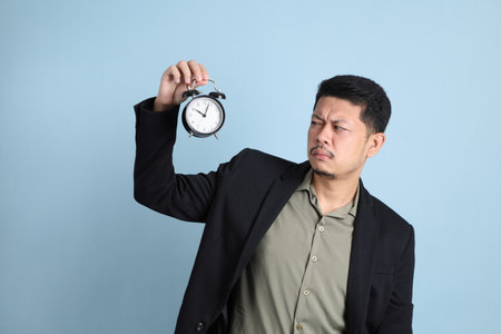 The adult business Asian man in smart casual clothes standing on the green background background.の写真素材