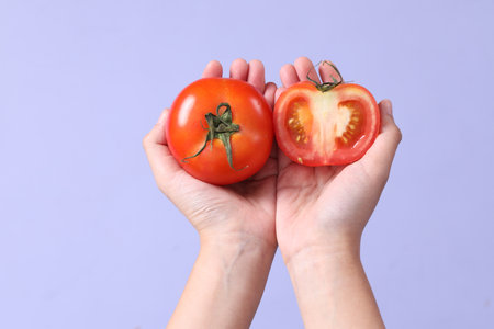 The Asian woman hand holding pomelo in the purple background.の写真素材