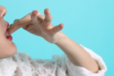 The Asian woman holding sushi on green background.の写真素材