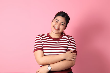 The Southeast Asian woman with braces standing on the colorful background.の写真素材