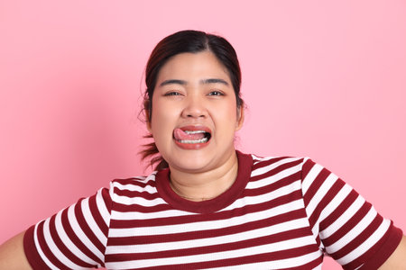 The Southeast Asian woman with braces standing on the colorful background.