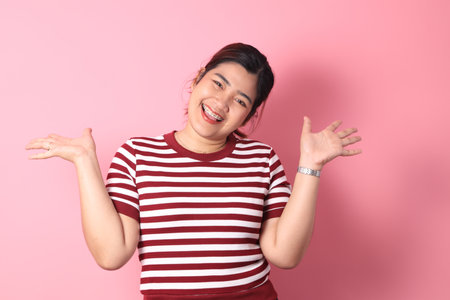 The Southeast Asian woman with braces standing on the colorful background.の写真素材