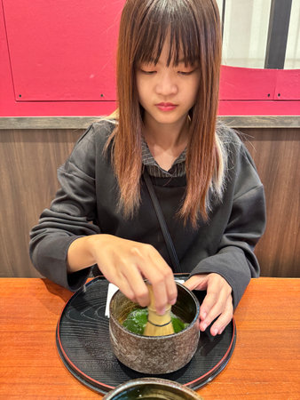 A happy Asian woman in the green tea-making class.の写真素材