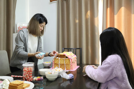 The mother is baking and decorating the house bread with help from her daughter for the upcoming...