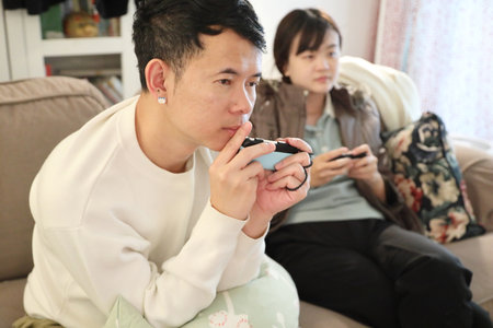 Two friends are playing and enjoying a video game together in the living room.