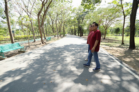 An East Asian senior couple takes a walk and relaxes in the park.の写真素材